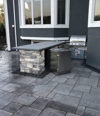 outdoor patio with grill and fridge